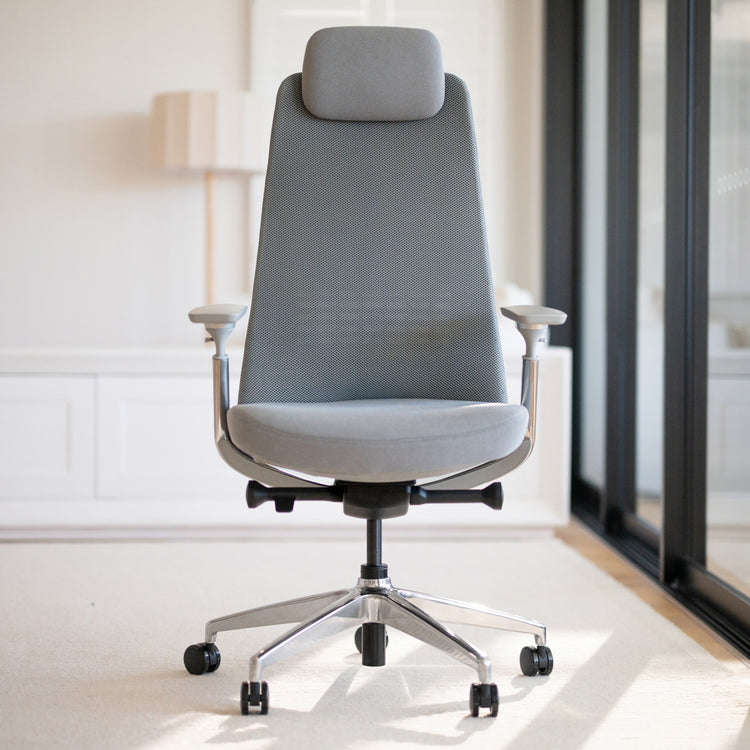 Gray Desky Pinnacle executive office chair with mesh back, soft fabric seat, adjustable headrest, and chrome base.
