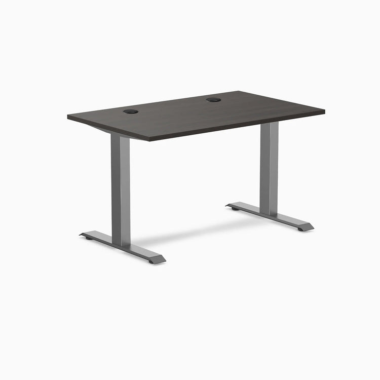 Desky Zero fixed height office desk with burnished wood laminate top, grommets, and space gray steel frame.
