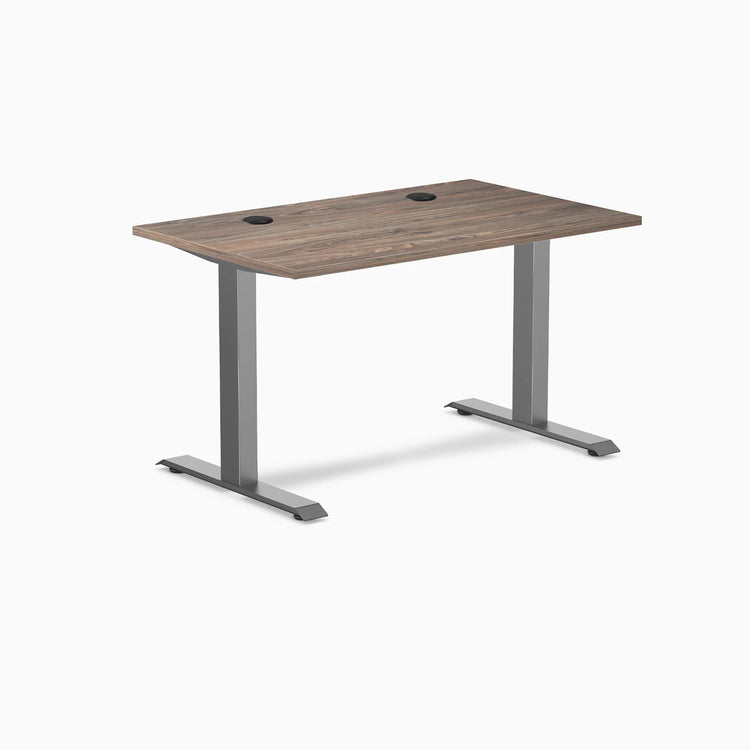 Desky Zero laminate office desk, natural walnut top with grommets, space gray steel frame.