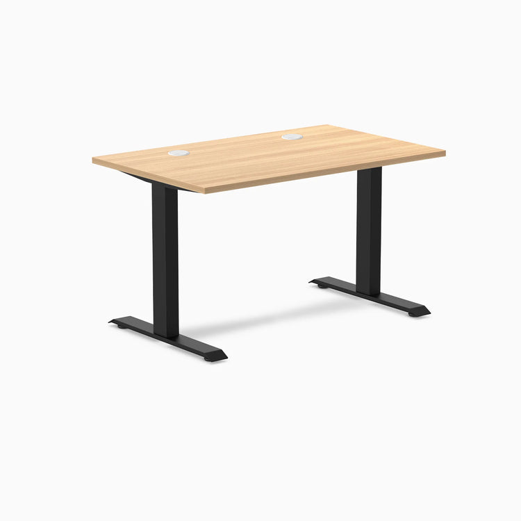 Desky Zero fixed-height office desk with Sublime Teak laminate top, two grommets, and matte black steel frame.