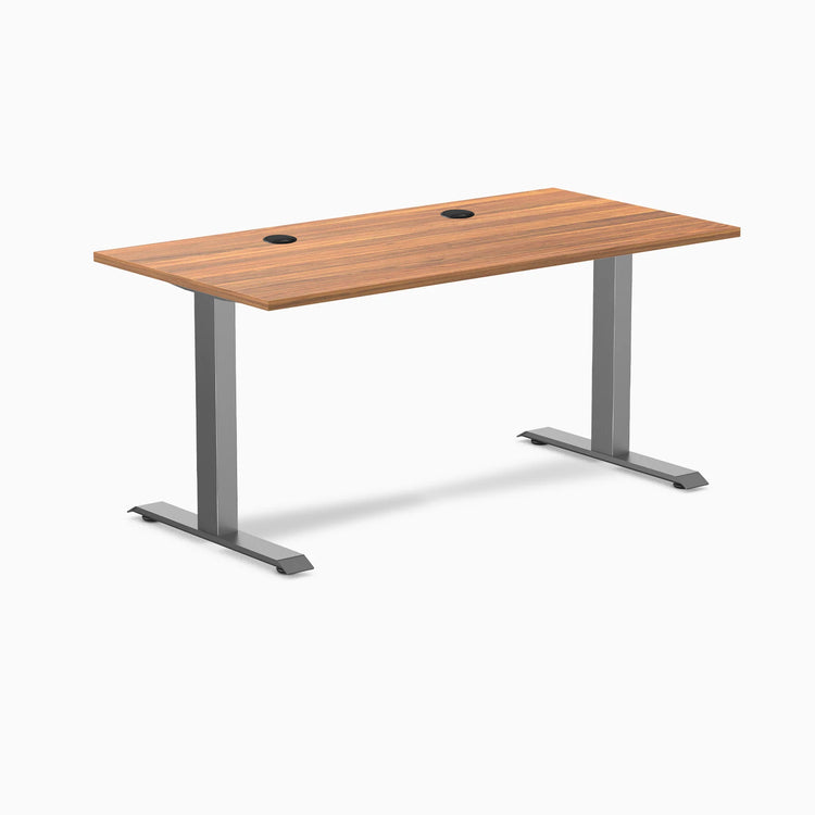 Desky Zero fixed height office desk with Prime Oak laminate top, Space Gray steel frame, and two grommets.