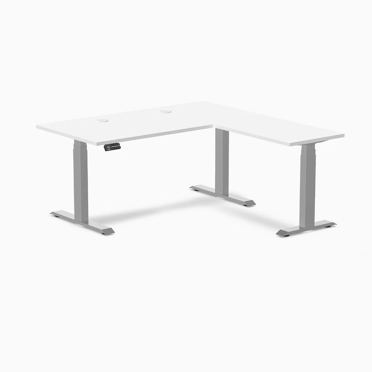 White Desky L-Shape Laminate Sit Stand Desk with gray adjustable legs and grommets.