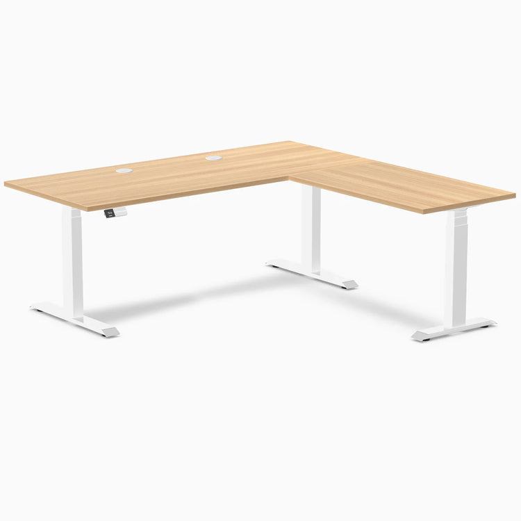 Desky L-Shape Laminate Sit Stand Desk in Sublime Teak with white frame and grommets.