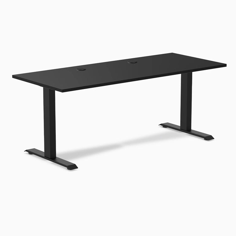 Desky Zero black laminate office desk, 70.9 x 29.5 inches, with two grommets and matte black steel frame.