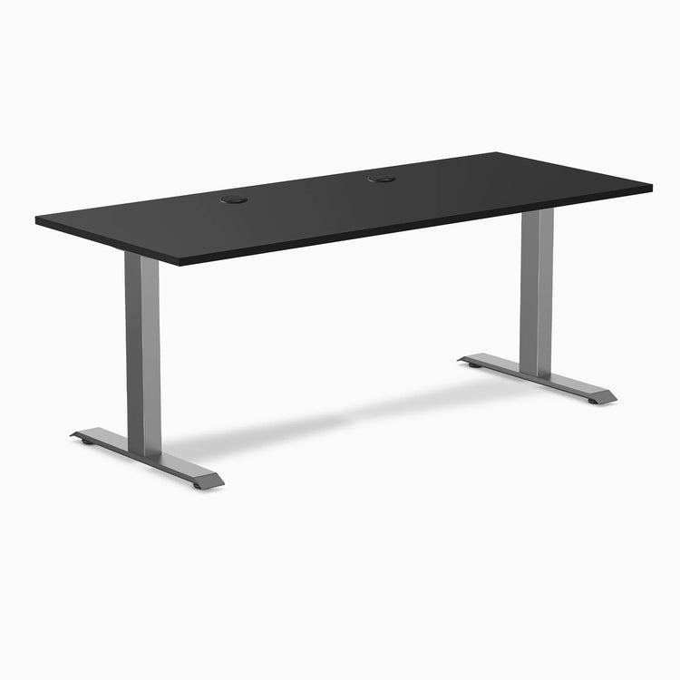 Desky Zero fixed-height office desk with black laminate top, space gray steel frame, and grommets.