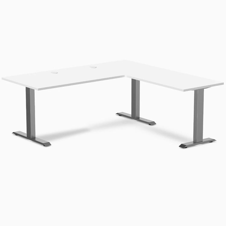 White Desky Zero L-shape laminate office desk with Space Gray steel frame and grommets.