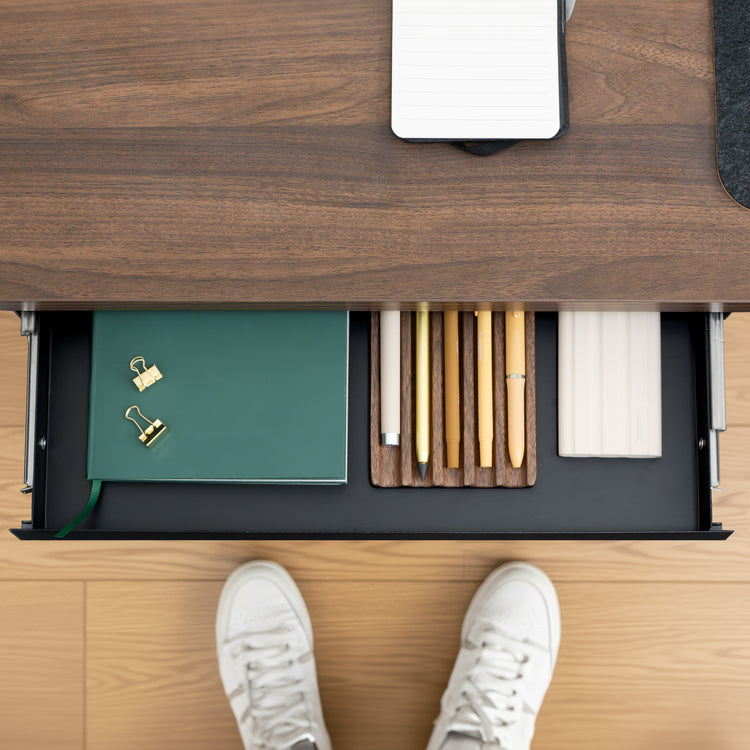 Black Desky Ultra Slim Under Desk Drawer, open with a green notebook, gold pens, and white notepad.