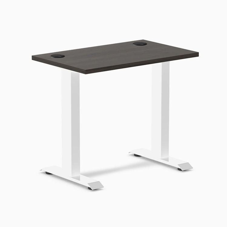 Desky Zero Mini fixed-height desk with burnished wood top, white legs, and two grommets.