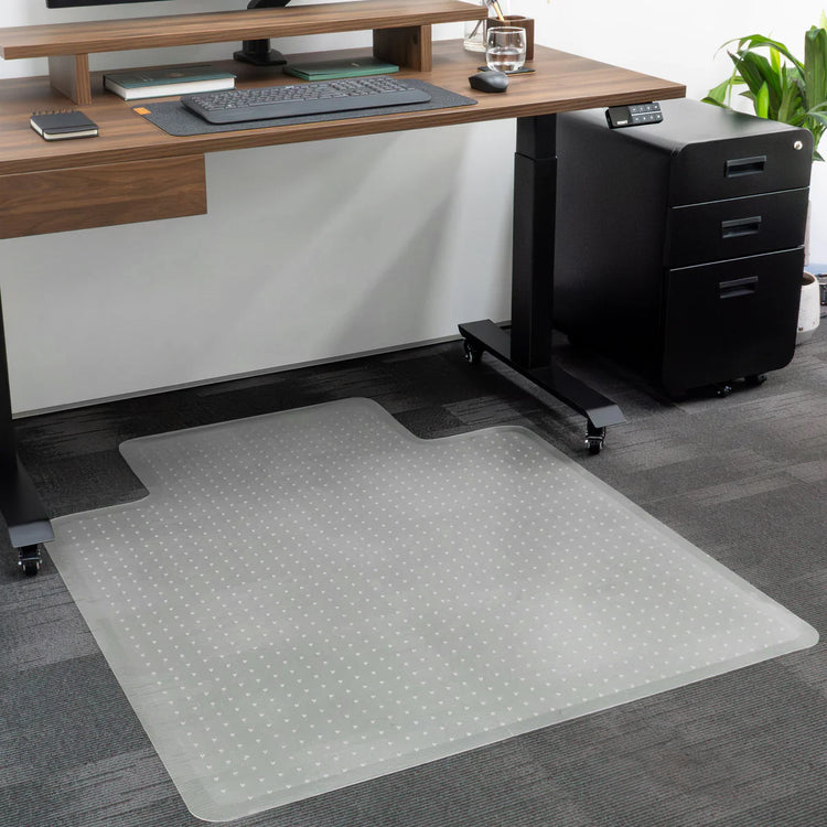 Translucent PVC Desky Chair Mat with key shape, protecting dark gray carpet under a wooden desk.