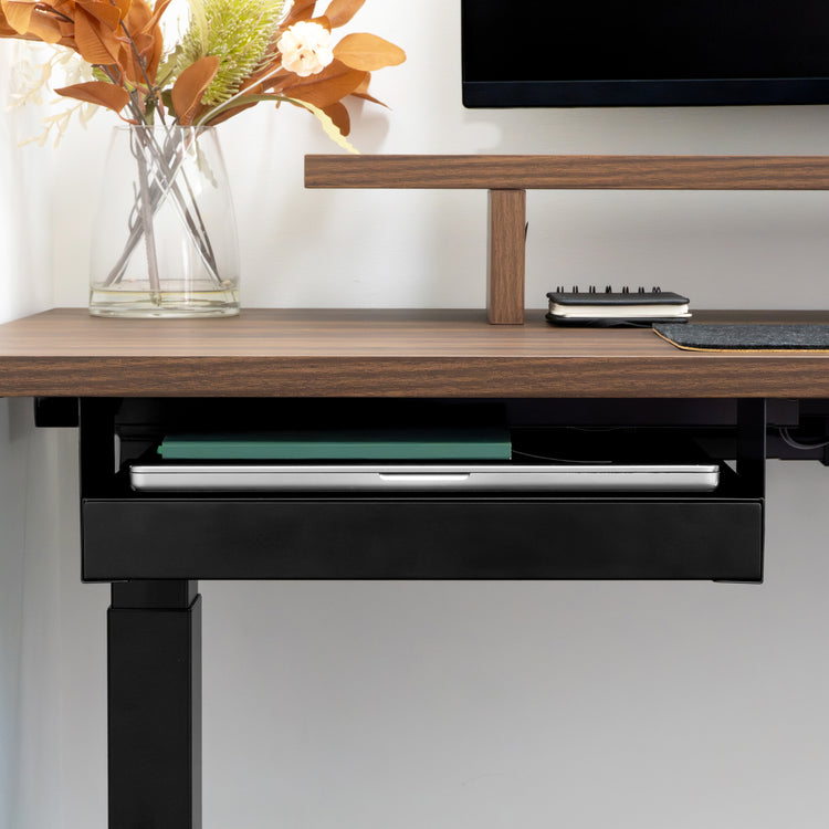 Black Desky Ultra Slim Under Desk Drawer with a laptop and book, mounted under a dark wood desk.