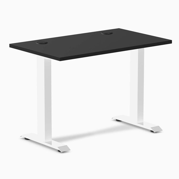 Desky Zero Mini fixed-height desk with black 40x24 inch top, white legs, and two grommets.