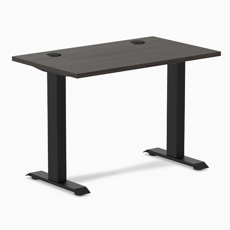 Desky Zero Mini sit-stand desk with burnished wood top, 40x24 inches, grommets, and matte black legs.