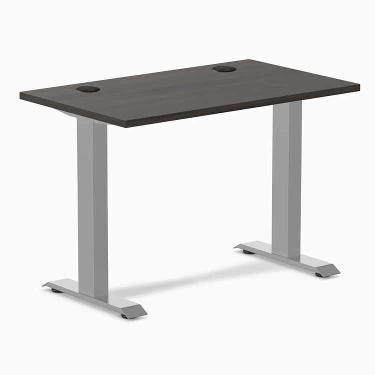 Desky Zero Mini sit-stand desk with burnished wood top, gray legs, and grommets.