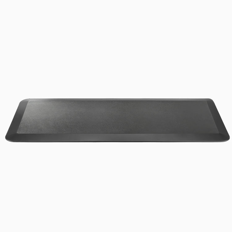 Desky black rectangular anti-fatigue standing mat with a rugged surface and bevelled edges.
