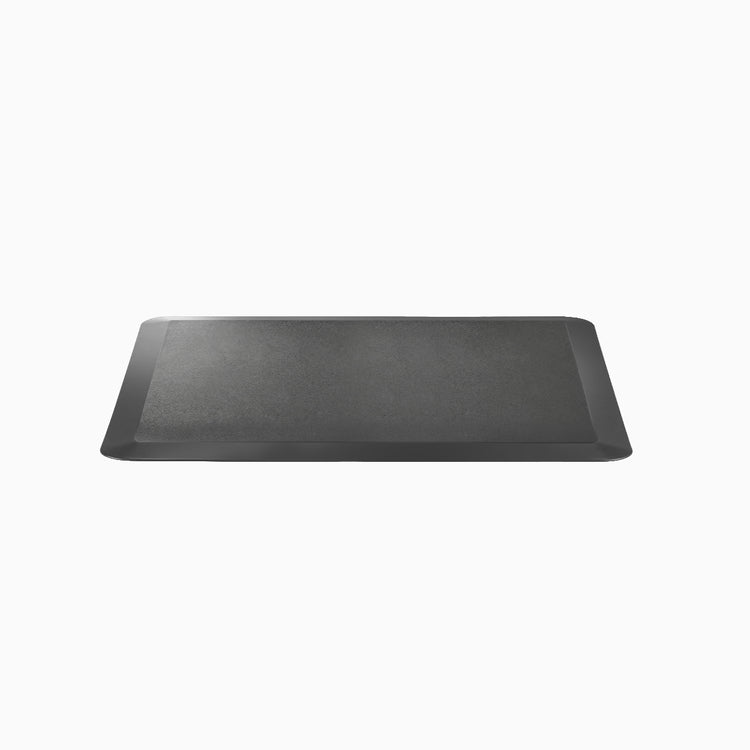 Black rectangular anti-fatigue standing mat with a rugged surface and bevelled edges.