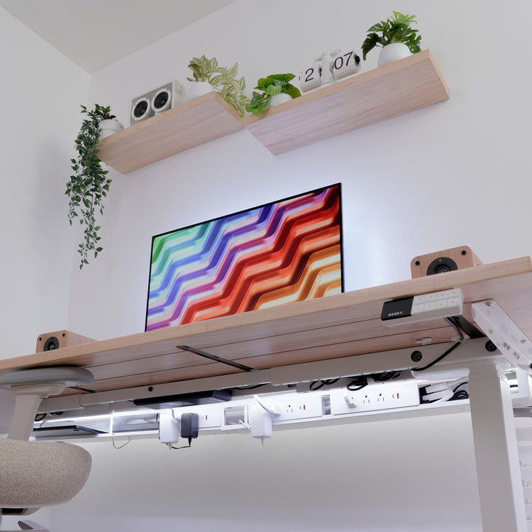 Desky integrated cable and power channel in white, neatly organizing cords under a light wood desk.