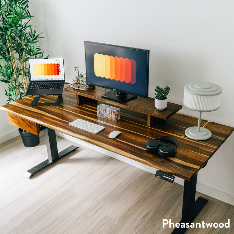 Pheasantwood hardwood standing desk with black legs, monitor riser, and integrated drawer.