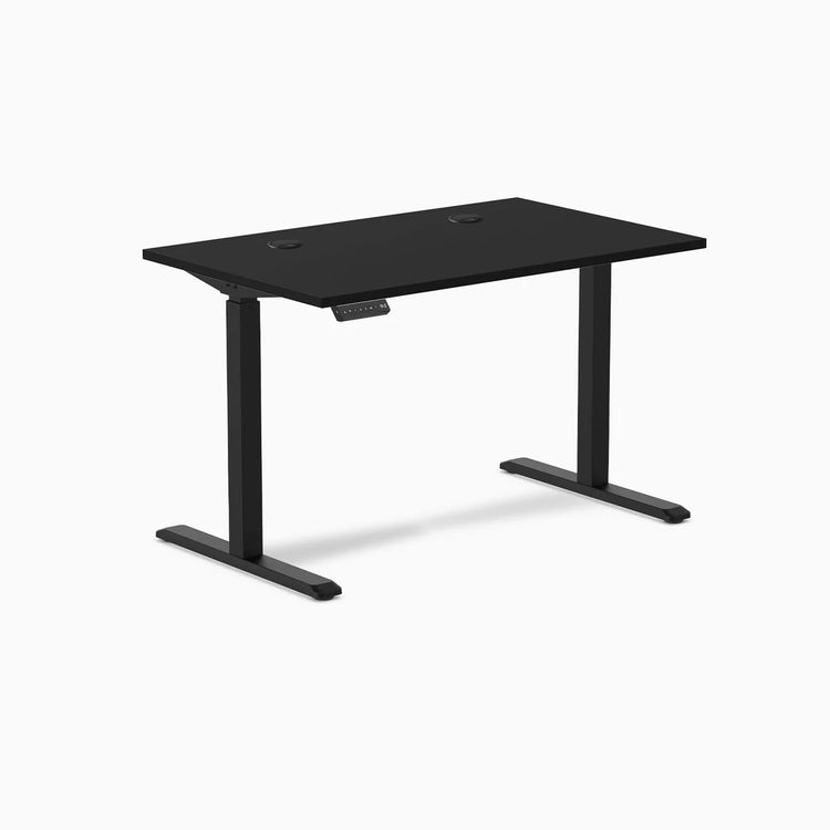 Black Desky Single Sit Stand Gaming Desk, 47.2 x 29.5 inches, with grommets and control panel.