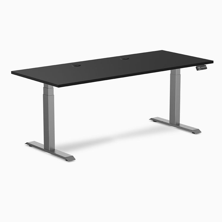 Desky Dual Laminate Sit Stand Desk, 70.9 x 29.5 inches, black top with grommets and space gray frame.