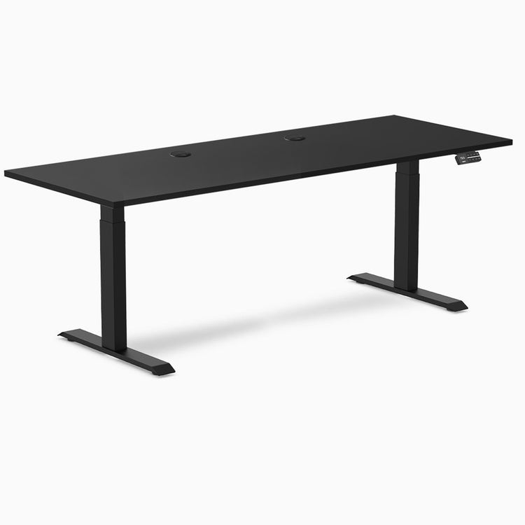 Black Desky Dual Laminate Sit Stand Desk, 78.7 x 29.5 inches, with grommets and matte black frame.