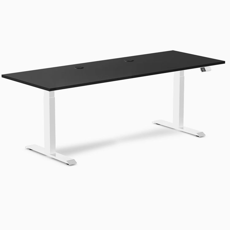 Black laminate sit-stand desk, 78.7x29.5 inches, with white frame, grommets, and digital control panel.