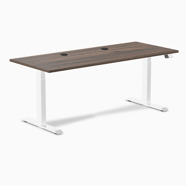 Desky Dual sit-stand desk with Jarrah Legno laminate top, white legs, and two grommets.