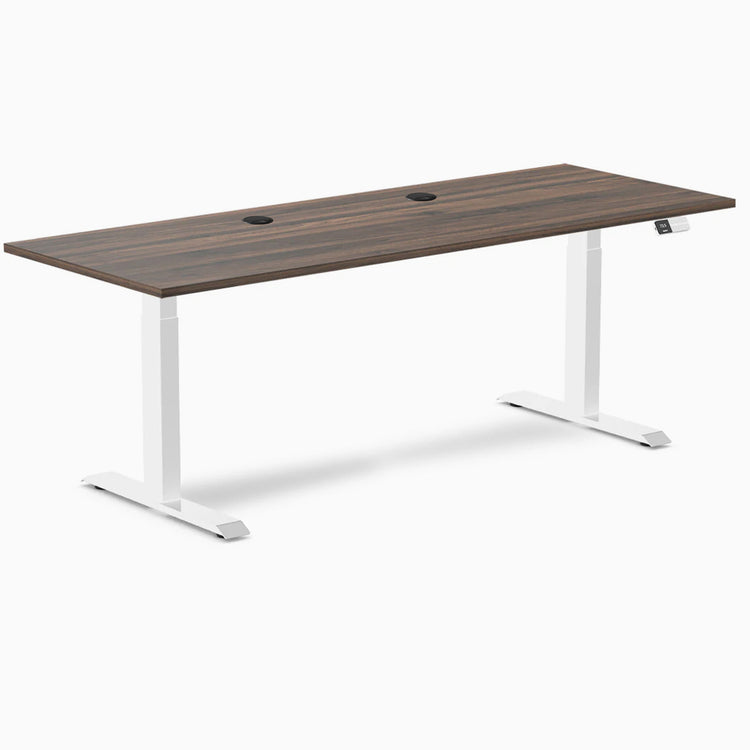 Desky Dual Laminate Sit Stand Desk with Jarrah Legno top, white frame, and two grommets.