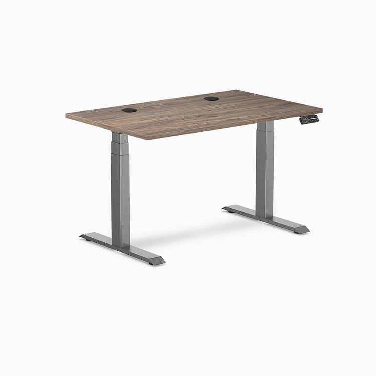Desky Dual Laminate Sit Stand Desk in Natural Walnut, 47.2x29.5 inches, with grommets and Space Gray frame.