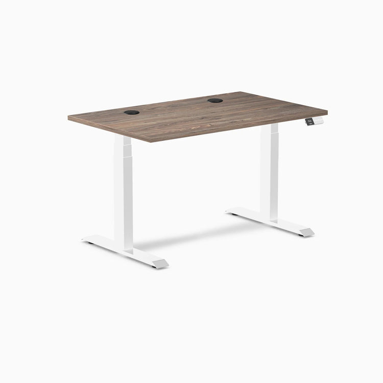 Desky Dual sit-stand desk with natural walnut laminate top, white frame, and two grommets.