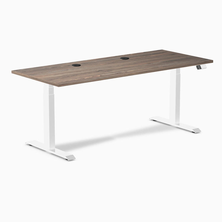 Desky Dual sit-stand desk with natural walnut laminate top, white frame, and two grommets.