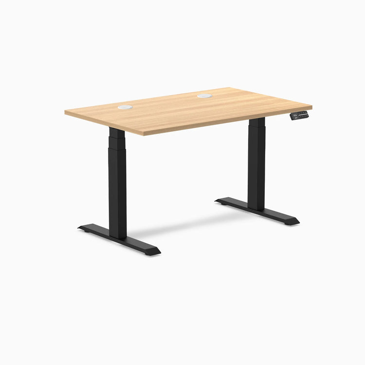 Desky Dual sit-stand desk with Sublime Teak laminate top, two grommets, and matte black frame.