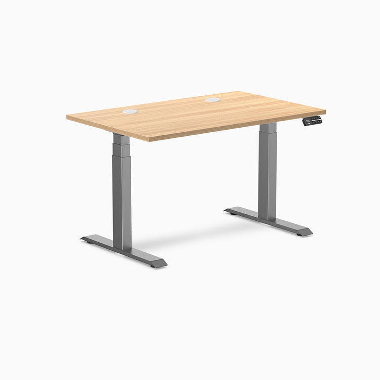 Desky Dual Laminate Sit Stand Desk in Sublime Teak, 47.2 x 29.5 inches, with grommets and Space Gray frame.