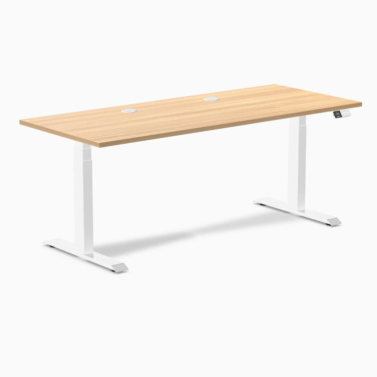 Desky Dual sit-stand desk with Sublime Teak laminate top, white frame, and two grommets.