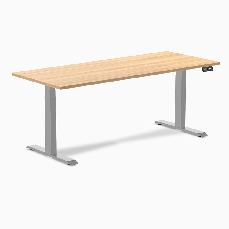 Desky Dual custom laminate sit-stand desk with a light wood top and silver adjustable legs.