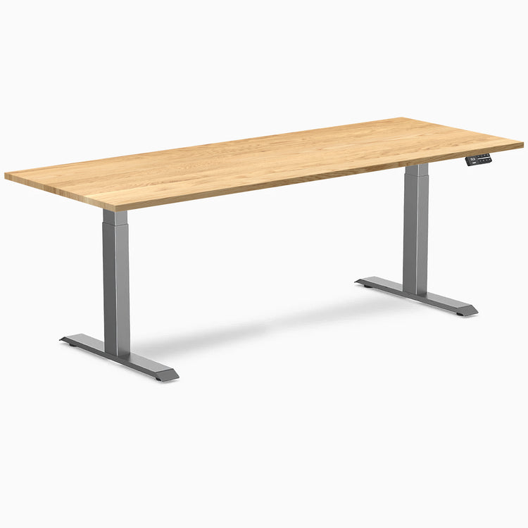 Desky Dual 80x30 inch White Oak hardwood sit-stand desk with Space Gray legs and control panel.