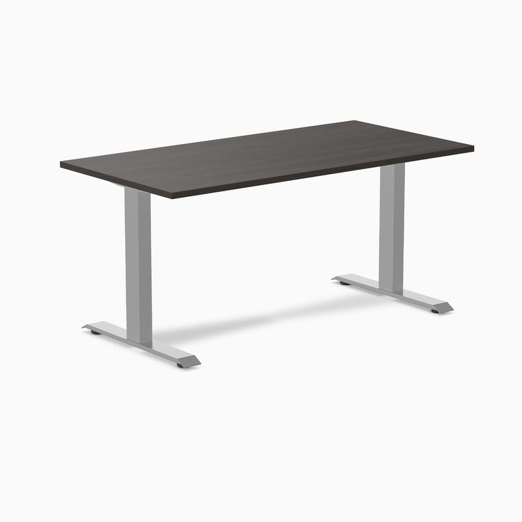 Desky Zero laminate office desk with a dark wood-grain top and silver steel I-frame legs.
