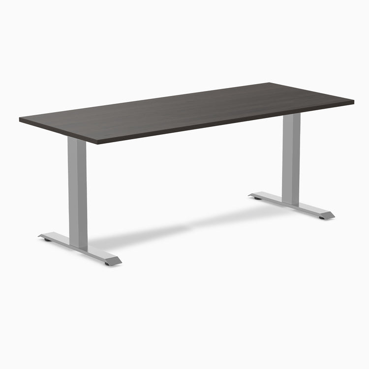 Desky Zero fixed-height office desk with dark laminate top and silver steel frame.