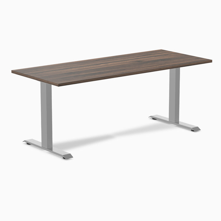 Desky Zero laminate office desk with dark wood-grain top and silver steel frame.
