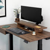Brown leather desk mat with keyboard, mouse, and monitor on a wooden standing desk.