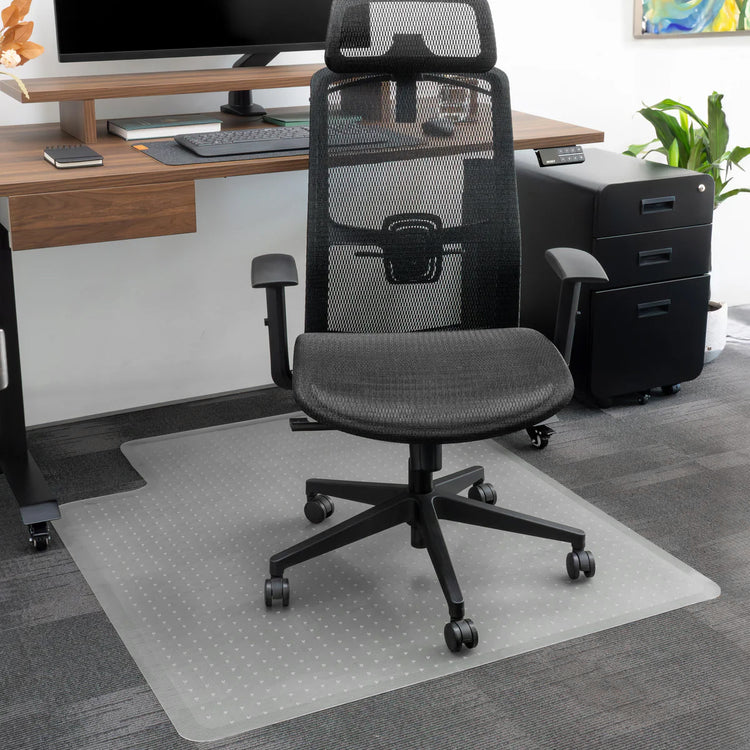 Translucent PVC Desky Chair Mat with key shape design under a black office chair on carpet.