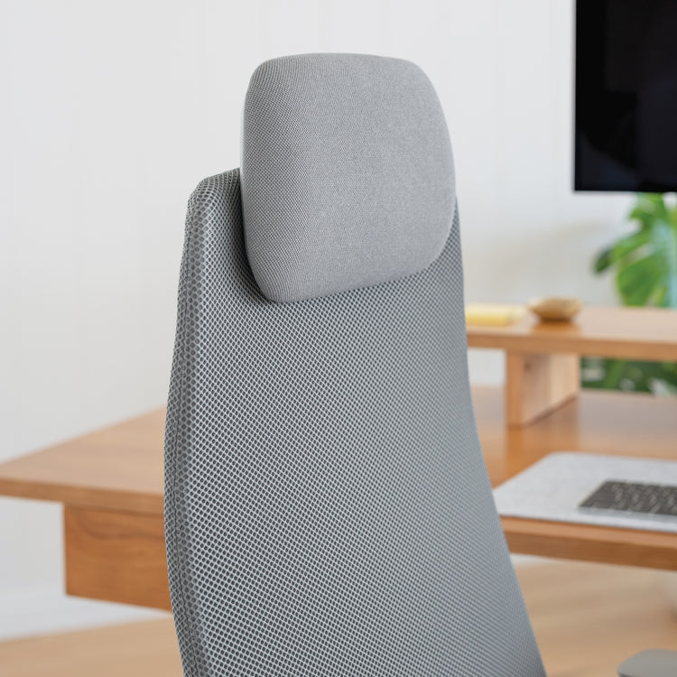 Close-up of the Desky Pinnacle Executive Office Chair's grey mesh backrest and adjustable headrest.