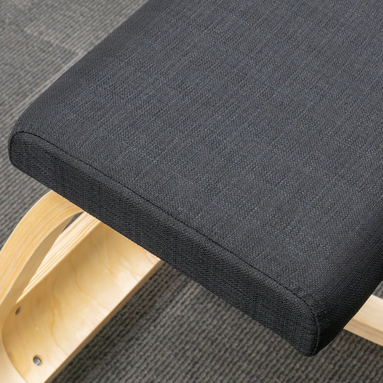 Desky Kneeling Chair with dark grey mesh cushion and light beechwood frame on a grey carpet.