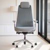 Gray Desky Pinnacle executive office chair with mesh back, soft fabric seat, adjustable headrest, and chrome base.