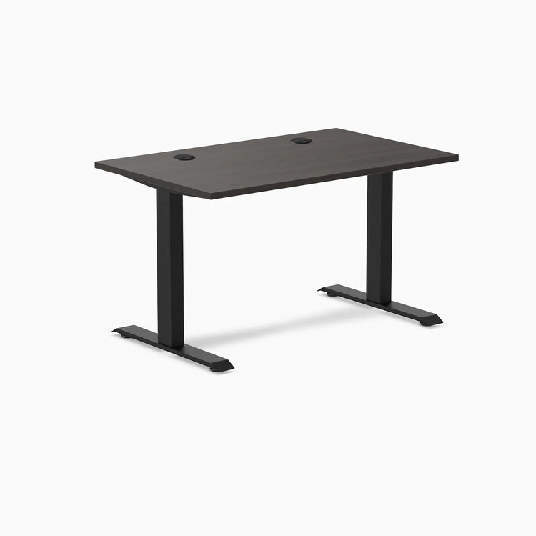 Desky Zero fixed-height office desk with burnished wood laminate top, grommets, and matte black steel frame.