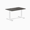 Desky Zero laminate office desk with burnished wood top, white steel frame, and two grommets.