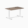 Desky Zero fixed height office desk with natural walnut laminate top, white steel frame, and grommets.
