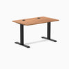 Desky Zero fixed height office desk with Prime Oak laminate top, black steel frame, and grommets.