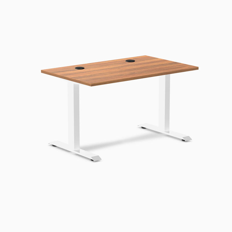 Desky Zero fixed height office desk with Prime Oak laminate top, white steel frame, and grommets.