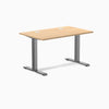 Desky Zero fixed height office desk with Sublime Teak laminate top, Space Gray steel frame, and grommets.