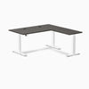Desky L-Shape Laminate Sit Stand Desk in Burnished Wood with white legs and grommets.